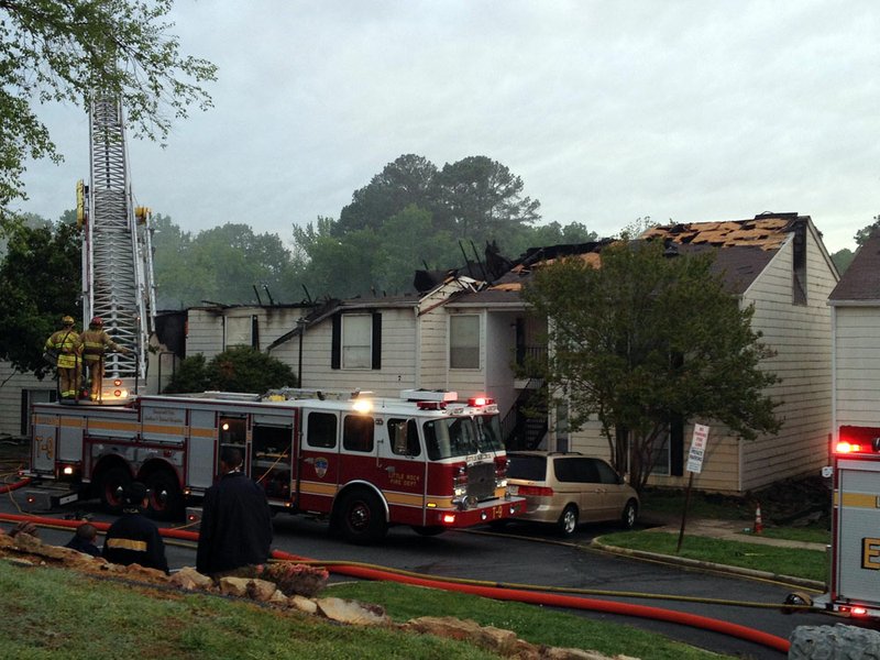 Firefighters battle a blaze Monday, April 29, 2013, at the Town Oaks Village apartments in Little Rock.