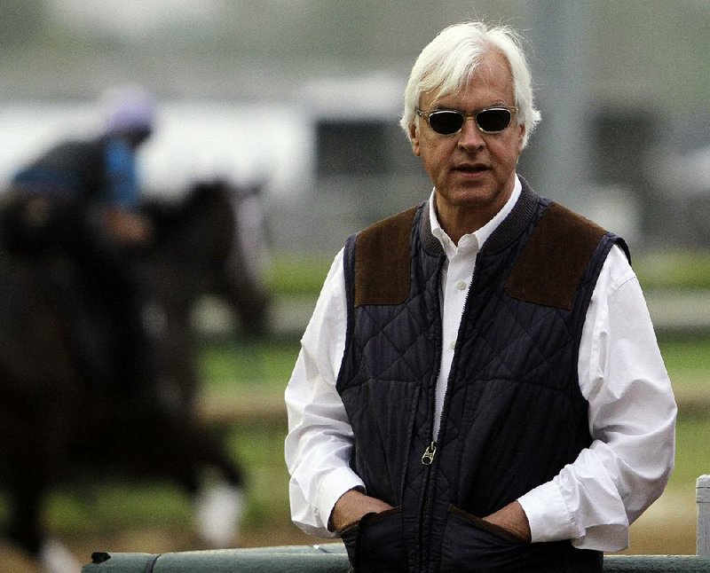 Trainer Bob Baffert watches morning workouts at Churchill Downs Monday, April 29, 2013, in Louisville, Ky. (AP Photo/Garry Jones)