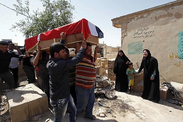 A bombing victim, Bashar Muhsin, 28, is taken for burial in Najaf, 100 miles (160 kilometers) south of Baghdad, Iraq, Monday, April. 29, 2013. Five car bombs exploded Monday in predominantly Shiite cities and districts in central and southern Iraq, killing and wounding dozens of people, police said. (AP Photo/Alaa al-Marjani)