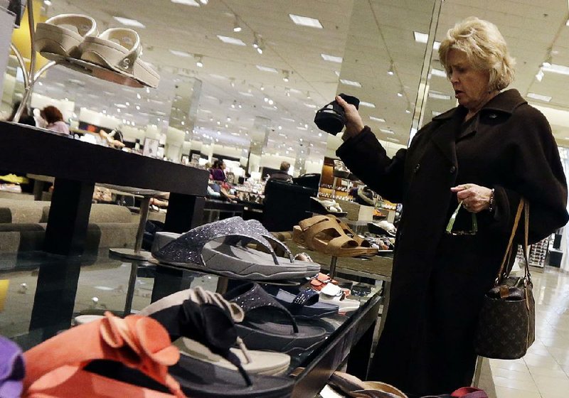 In this Thursday, March 28, 2013, photo, a woman shops at a store in Chicago. The government reports how much consumers spent and earned in March on Monday, April 29, 2013. (AP Photo/Nam Y. Huh)