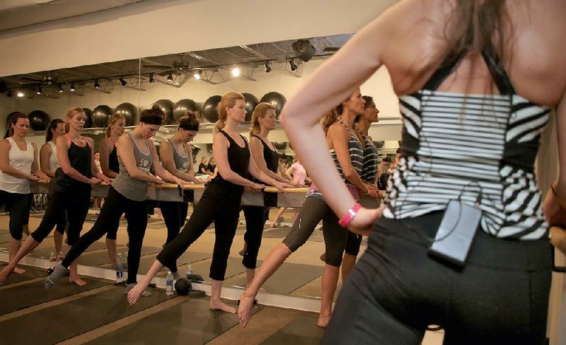 Instructor Alex Jenner (far right) has her BarreAmped students do seemingly endless sets of pulsing leg lifts at ZenSpin studio in LIttle Rock. 