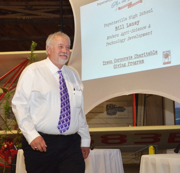 Bill Laney with Fayetteville High School walks up to accept a $25,092 grant for new equipment for the school’s Agri Complex on Monday evening during the 13th annual Fayetteville Public Education Foundation’s Sky’s the Limit Celebration of Excellence for the 2013-14 grant recipients at the Fayetteville Air Museum. Thirty-six teachers with the Fayetteville School District received $161,000 in grants for resources and programs for their students. 