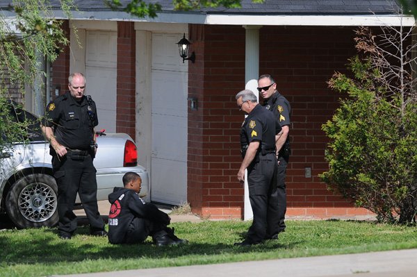 Springdale police officers, from left, officer Robert Nelson, Sgt. Lee Andreadis and Sgt. Shane Pegram talk to a man Monday at 3214-B Singletree Ave. in Springdale in connection with a stabbing at that address. A man claimed his roommate stabbed him. The first call came to dispatchers at 9:48 a.m. Monday. The man was not transported to the hospital. The suspect was taken by police for questioning. 