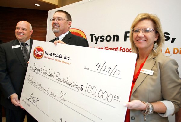 Anetta Young, director of corporate philanthropy at Tyson Foods Inc., from right, stands with Mike McFarland, chairman of the Springdale Public Schools Education Foundation, and Chris Stecklein, executive director, Monday after announcing Tyson has awarded $100,000 to the Springdale Public Schools Education Foundation. The foundation’s mission is to provide resources that enhance educational and enrichment opportunities for Springdale Public School Students. 