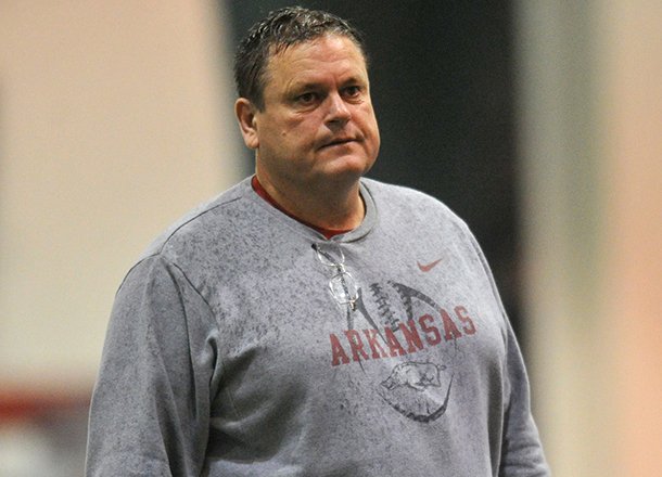 Arkansas assistant coach Sam Pittman works with the Razorbacks during practice March 30, 2013 in Fayetteville.