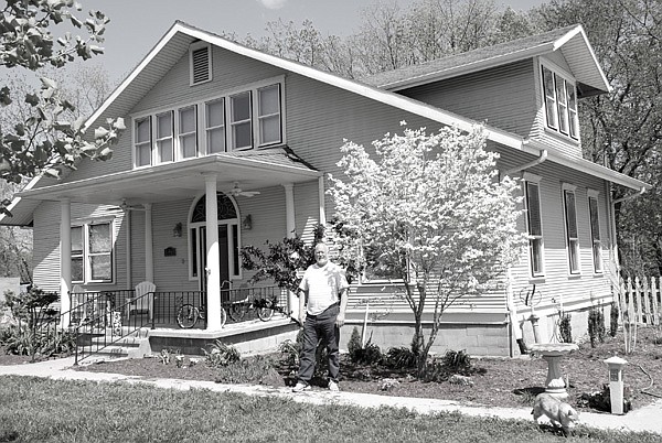 Tom Snead stands in front of his historic home once owned by H.L. Stroud, Tom Morgan and Vera Key. Tom and Marty Snead restored the Rogers home. 