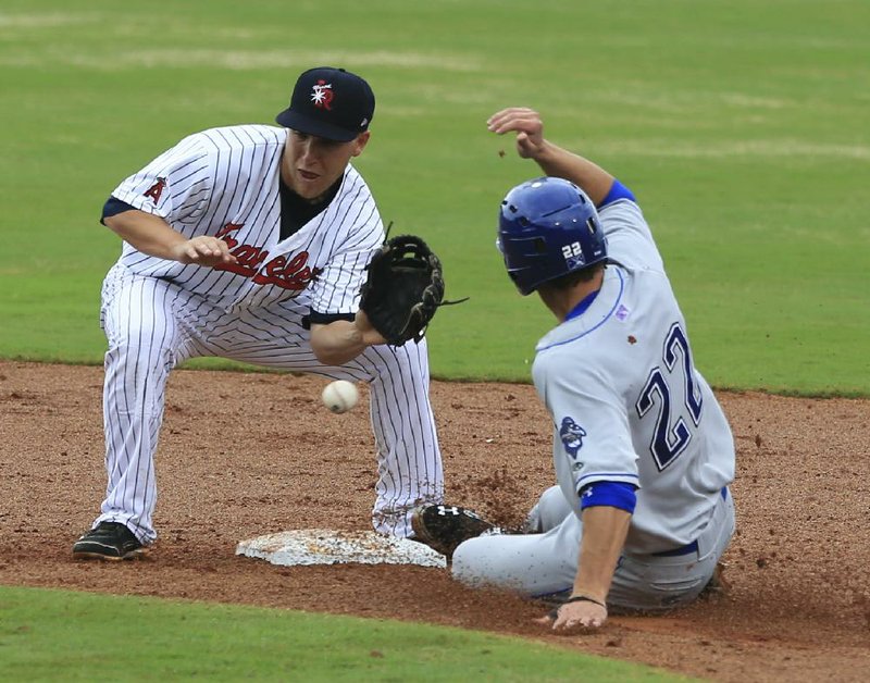 Arkansas second baseman Taylor Lindsey misplayed a ball on a steal attempt by Tulsa’s Kent Matthes (right), but he made up for it with a game-winning home run in the ninth inning. 