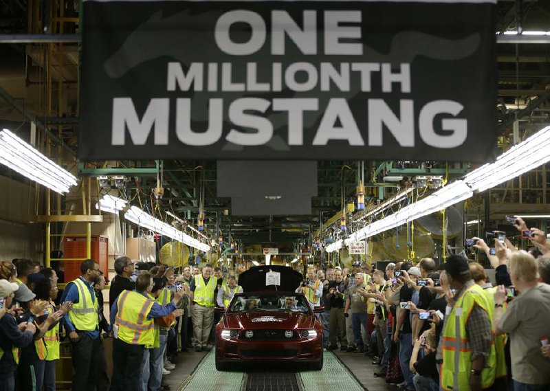 Employees at Ford’s Flat Rock Assembly Plant in Flat Rock, Mich., cheer April 17 as the millionth Ford Mustang is driven off the assembly line. U.S. factory activity expanded at a slower pace in April compared with March as manufacturers pulled back sharply on hiring and cut their stockpiling. 