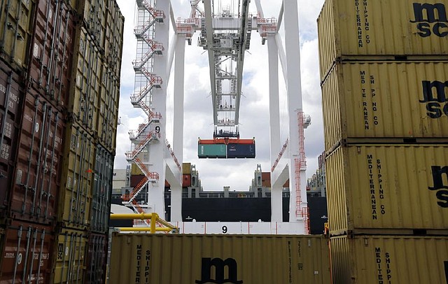A crane moves a container from a ship at the Port of Baltimore’s Seagirt Marine Terminal in March. The U.S. trade deficit narrowed in March, the Commerce Department said Thursday. 