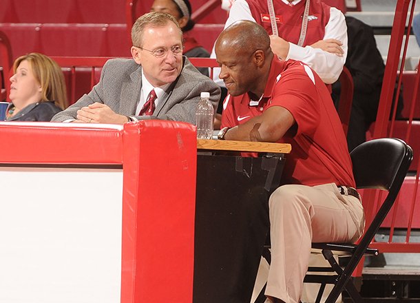 Arkansas athletics director Jeff Long, left, talks with Arkansas head basketball coach Mike Anderson during the Red/White scrimmage Tuesday, Oct. 30, 2012, at Bud Walton Arena in Fayetteville.