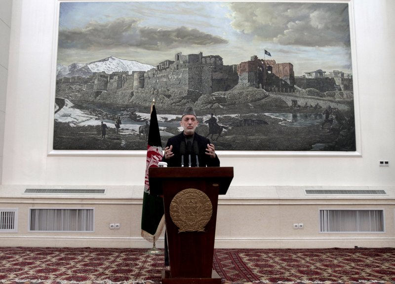 Afghan President Hamid Karzai speaks during a news conference in Kabul, Afghanistan, Saturday, May 4, 2013. Karzai says the director of the CIA assured him that regular funding his government receives from the agency will not be cut off. He says Afghanistan has been receiving such funding for more than 10 years and expressed hope at a Saturday news conference that it will not stop