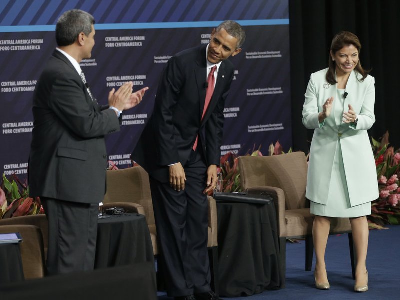 U.S. President Barack Obama, center, is introduced at a forum on Inclusive Economic Growth and Development at the Old Custom House in San Jose, Costa Rica, Saturday, May 4, 2013. On stage with Obama are INCAE University President Arturo Condo, left, and Costa Rica’s President Laura Chinchilla, right.