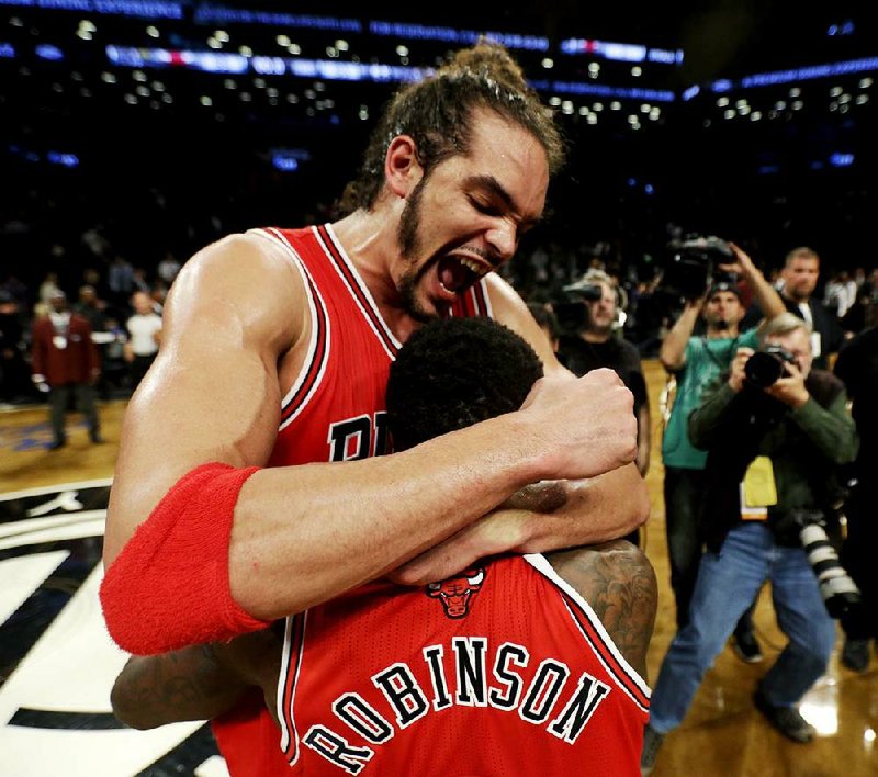 Chicago’s Joakim Noah (left) celebrates with teammate Nate Robinson after the Bulls eliminated the New Jersey Nets 99-93 in their first-round NBA Eastern Conference playoff series. 