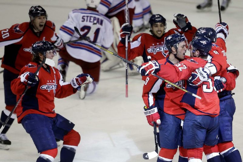 Washington Capitals defenseman Mike Green (right) is congratulated by teammates after scoring the game-winning goal in overtime Saturday. 