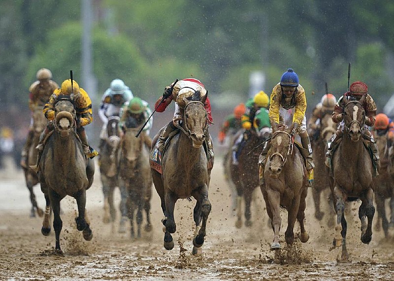 Jockey Joel Rosario (center) celebrates aboard Orb as he crosses the finish line in the Kentucky Derby at Churchill Downs on Saturday in Louisville, Ky. Orb, who trailed by a large margin heading into the final turn, used a late charge to claim the first Derby victory for trainer Shug McGaughey and owners Stuart Janney and Ogden Mills “Dinny” Phipps. 