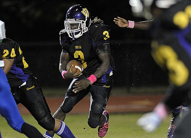 South Plantation running back Alex Collins looks for a hole in the Coral Springs defense in this October 21, 2011, file photo. (Michael Laughlin/Sun Sentinel/MCT)