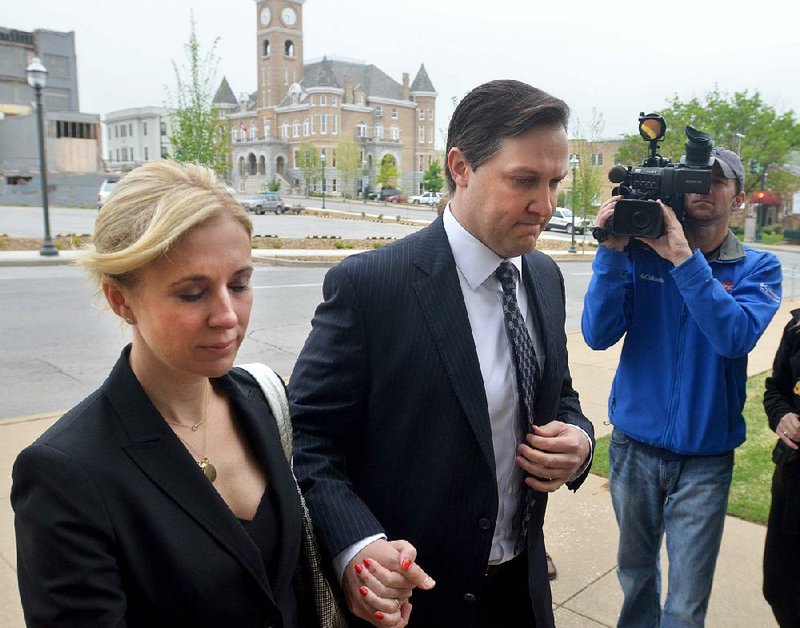 Former developer Brandon Barber,right, is escorted into the John Paul Hammerschmidt Federal Building by associate Kristen Foodim, left, Monday, May 6th, 2013, in Fayetteville.  Barber has been charges with 27 counts of conspiracy and wire-, bank- and bankruptcy fraud.