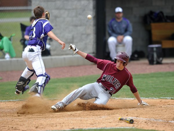 Cord McCaslin of Lincoln scores a run in the third inning as Booneville catcher Jacob Krepps takes the throw during Monday’s 4A North Regional game in Farmington. 