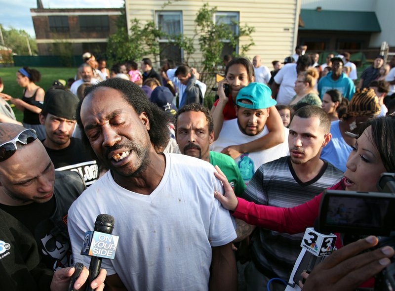 Neighbor Charles Ramsey speaks to media near the home on the 2200 block of Seymour Avenue, where three missing women were rescued in Cleveland, on Monday, May 6, 2013. 