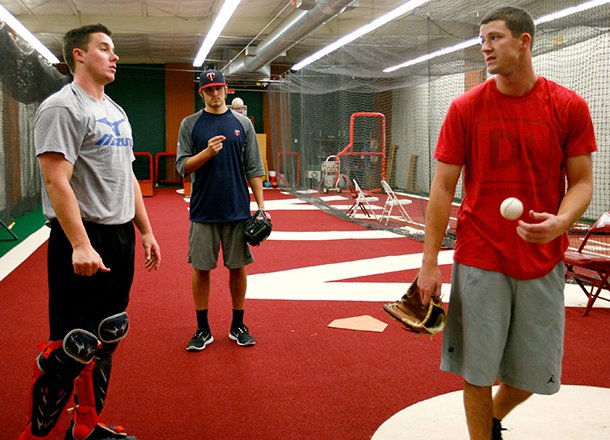 Former Razorback catcher James McCann (from left) and former Razorback pitchers DJ Baxendale and Drew Smyly chat while training on Wednesday, Jan. 30, 2013, at Baum Stadium in Fayetteville.