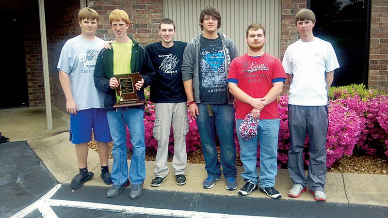 From the left, Eric Vest, Andrew Walker, Marcus McCormick, Cary Behm, Chandler Holt and coach Steven Walker pose with the trophy the team received for winning the Class 1A/2A State Chess Championship in Beebe on April 27. This is the team’s first state title since 2008.