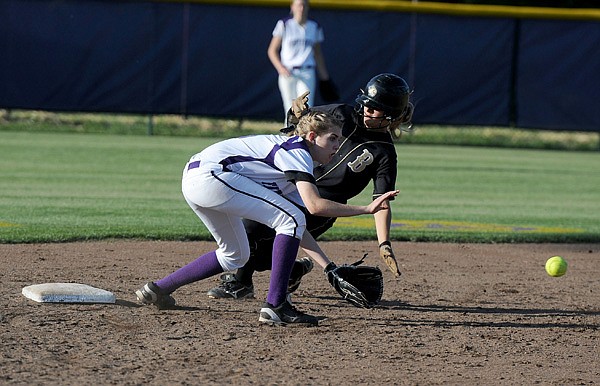 Stephanie Hughes, left, of Fayetteville looks for the throw as Bentonville’s Emma Kinsey steals second Tuesday at Lady Dawg Yard in Fayetteville. Kinsey was safe on the play. 
