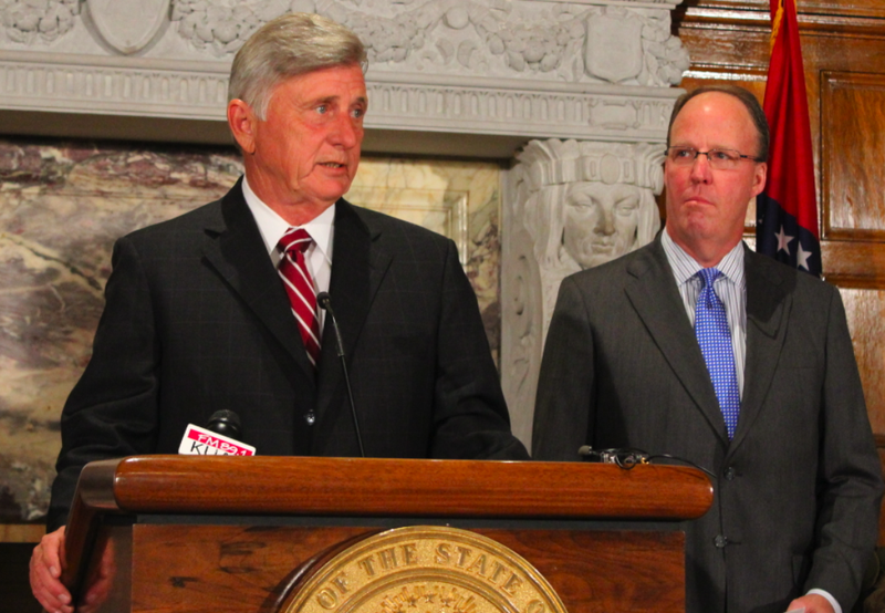 Gov. Mike Beebe speaks while Midcontinent Independent System Operator President and CEO John Bear looks on Wednesday at the state Capitol.