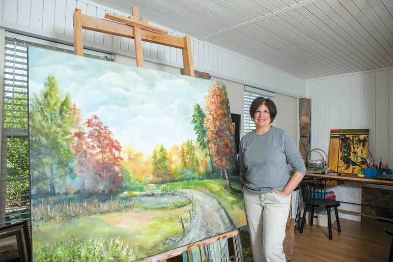 Susan Peterson displays one of her paintings in her art studio, which will be one of the stops Saturday on the Conway League of Artists’ Studio and Gallery Tour.