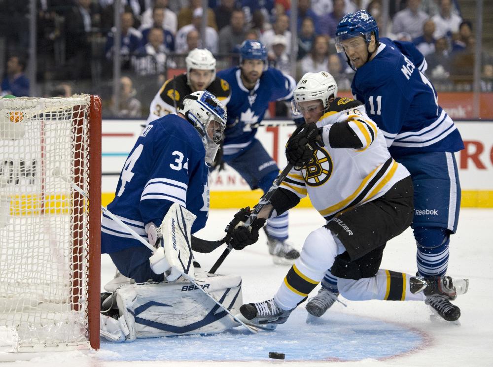 Toronto Maple Leafs' Jay McClement (11) and Boston Bruins' Tyler Seguin (19) look for the puck as Maple Leafs goalie James Reimer makes a save during the first period of Game 4 of an NHL hockey Stanley Cup playoff series, Wednesday, May 8, 2013, in Toronto. (AP Photo/The Canadian Press, Frank Gunn)