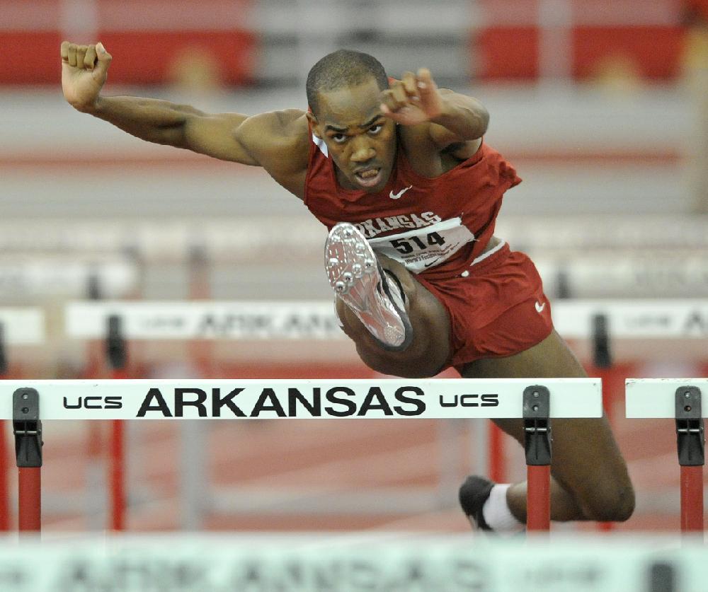 NWA Media/MICHAEL WOODS  --02/87/2013--  University of Arkansas hurdler Caleb Cross clears a hurdle on his way to the finish line in the mens 60m hurdle finals at the Tyson Invitational track meet at the Randal Tyson Track Complex in Fayetteville.