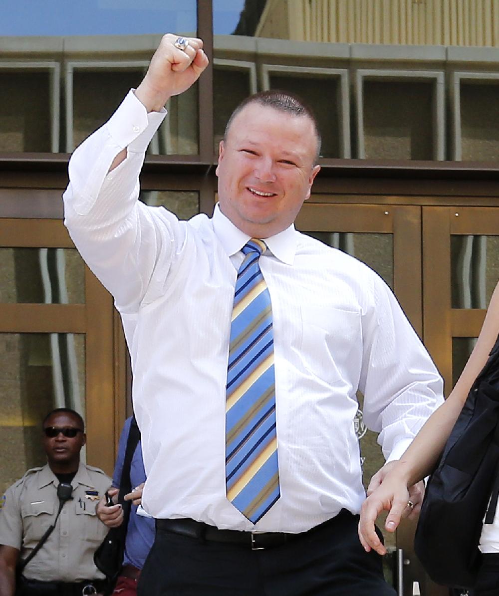David Hall, a friend of Travis Alexander, pumps his fist outside Superior Court in Phoenix, Wednesday, May 8, 2013 to a guilty verdict in the trial of Jodi Arias. Arias was a waitress and aspiring photographer charged with killing her boyfriend, Travis Alexander, in Arizona in 2008. The four month trial included graphic details of their sexual escapades and photos of Alexander just after his death. (AP Photo/Matt York)