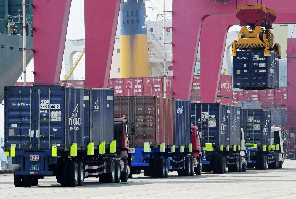 FILE - In this Wednesday, April 10, 2013 file photo, a shipping container is craned to a containership at a port in Qingdao in east China's Shandong province. China's trade accelerated in April in a possible positive sign for its shaky economic recovery. Exports rose 14.7 percent over a year earlier, up from March's 10 percent growth, customs data showed Wednesday, May 8. Imports gained 16.8 percent, up from the previous month's 14.1 percent. (AP Photo/File) CHINA OUT