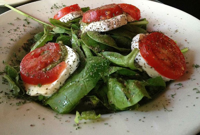 Ciao’s Vine Ripe Tomato and Mozzarella appetizer comes on a bed of spinach, with pesto replacing out-of-season fresh basil. 