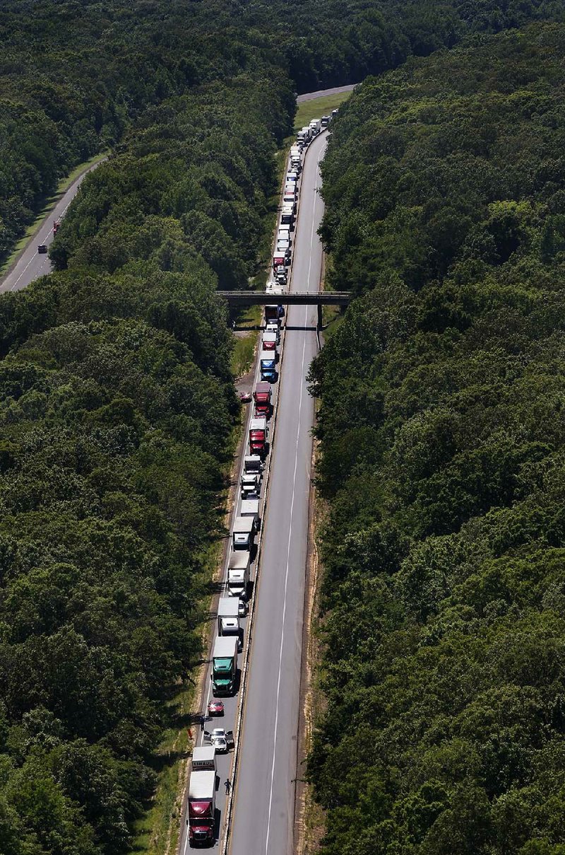 Vehicles are stopped along a section of Interstate 40 for more than five hours after an accident killed at least one person and closed the interstate near the White River bridge east of Hazen on Wednesday. 