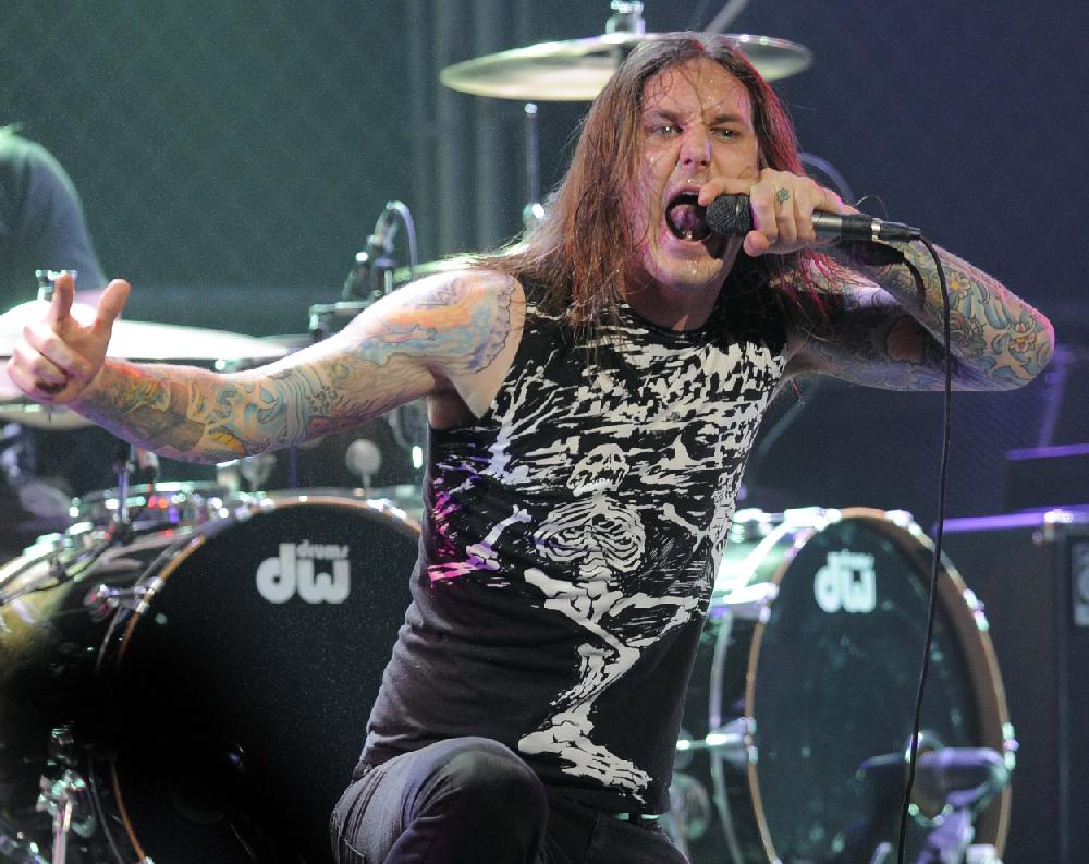 FILE - In this file photo taken Thursday, April 8, 2010, Tim Lambesis of As I Lay Dying performs at the second annual Revolver Golden Gods Awards in Los Angeles. Authorities say the singer of Grammy-nominated heavy metal band As I Lay Dying has been arrested Tuesday May 7, 2013 in Southern California after trying to hire an undercover detective to kill his estranged wife. The San Diego County Sheriff’s Department says in a statement that 32-year-old Tim Lambesis was arrested Tuesday in Oceanside. (AP Photo/Chris Pizzello, File)