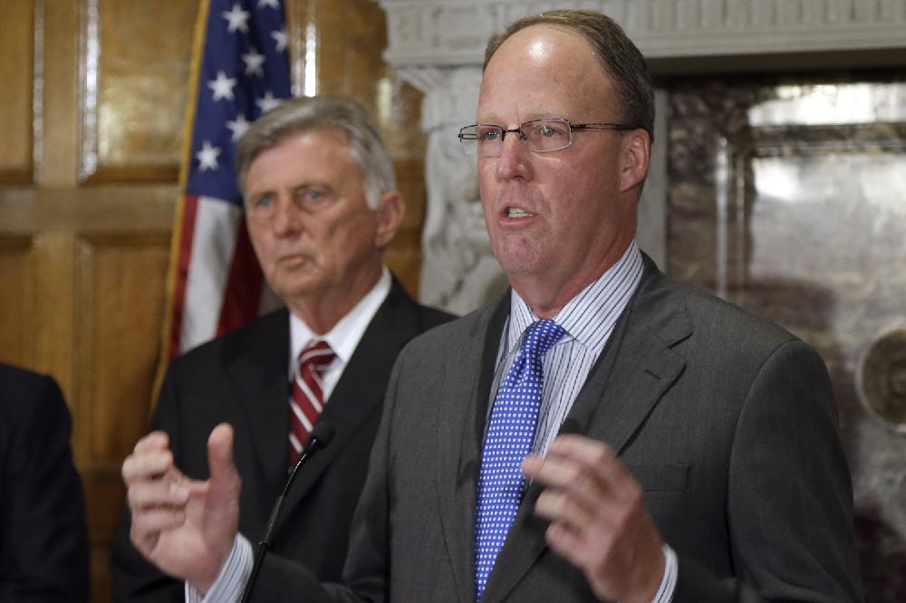 John R. Bear, right, president and chief operating officer of Midcontinent Independent System Operator, announces MISO's plan at the Arkansas state Capitol in Little Rock, Ark., Wednesday, May 8, 2013, to build a facility in Little Rock and hire up to 50 employees who will earn an average annual salary of $85,000. Arkansas Gov. Mike Beebe, left, listens.(AP Photo/Danny Johnston)