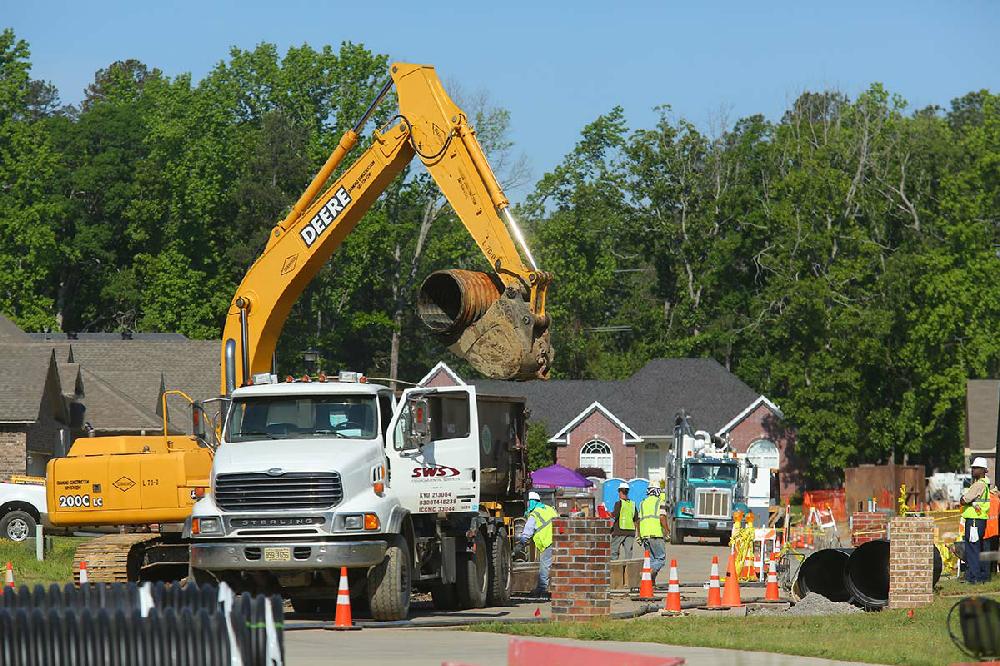 5/8/13
Arkansas Democrat-Gazette/STEPHEN B. THORNTON
Worker load old drainage pipes, top, being replaced by new ones, bottom left and bottom right, on N. Starlite in Mayflower's Northwood subdivision. The pipes run along the front yards of homes most effected by March's oil spill on the street.