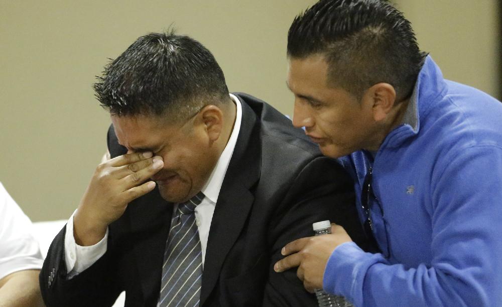 A unidentified man breaks down as another looks on hug during a public wake for Ricardo Portillo Wednesday, May 8, 2013, in Salt Lake City. People attended the wake to honor the Utah soccer referee who was punched by a player and later died after a weeklong coma. (AP Photo/Rick Bowmer)