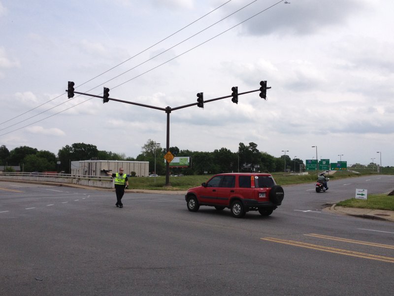 Little Rock police direct traffic at an intersection. Numerous traffic lights are among the entities without power on Thursday afternoon due to an outage in the area.