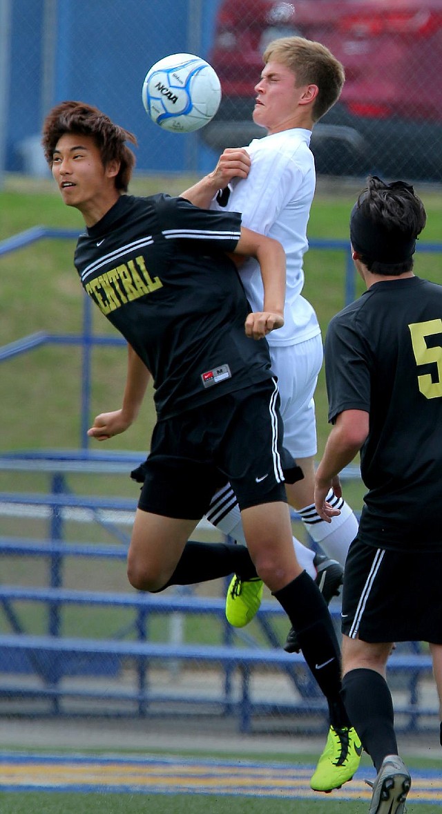 Little Rock Central’s Ian Kim (left) and Bentonville’s Bennett Moehring battle for the ball in the Class 7A state tournament at North Little Rock. 