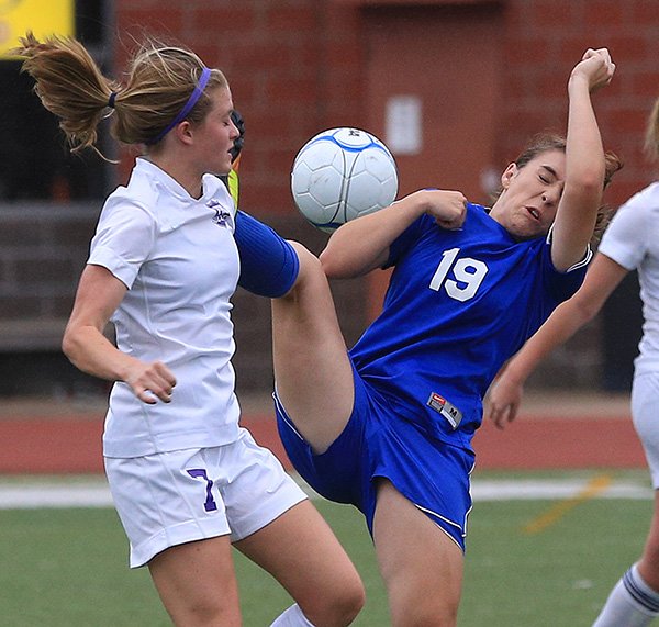 Fayetteville’s Kara Tubb, left, and Conway’s Addie Smith fight for the ball Thursday night during their 7A state tournament game in Cabot. 