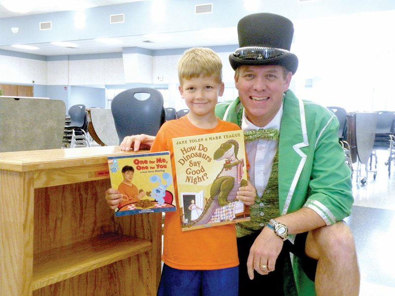Brian Ratliff, The Toad Master of the Toad Suck Daze festival and director of the children’s ministry at Antioch Baptist Church, congratulates Dylan Mullins on receiving a personalized bookcase and a box of books from the Greenbrier Bookcase for Every Child Project. Dylan, 5, is the son of Melinda Smith and is in the preschool program at Westside Elementary School in Greenbrier.