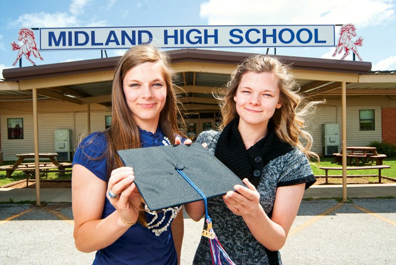 Twin sisters Destany Standard Lytle, left, and Felisha Standard will graduate from Midland High School on Thursday. The sisters have often been mistakenly identified, and there is only one minute’s difference in when they were born. Both have the same grade-point average of 3.5.