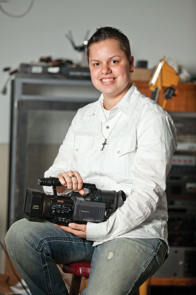 Caroline Stone, 18, who is profoundly deaf and has a cochlear implant, holds a camera in IMC Studios in Russellville. Her dream is to work in the movie industry, possibly creating animation to go with film theme songs. She also enjoys dancing, singing and playing guitar and drums. She will graduate Friday from Russellville High School and will attend the University of Central Arkansas this fall.