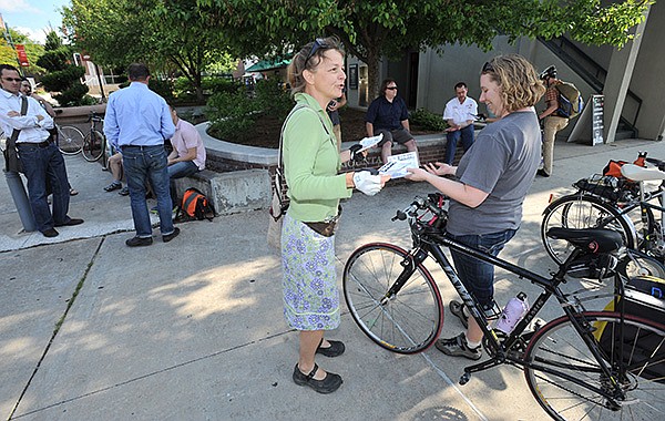 Laura Kelly, center, a longtime bicycling advocate, speaks Friday with Kristin Klemm during an announcement to declare May 12-18 as Bike To Work Week on the Fayetteville square before riders left for a crosstown ride along the city's trail system. Residents are encouraged by the city and Bicycle Coalition of the Ozarks to ride their bicycles to work during the coming week and residents of Benton and Washington counties can track their mileage to be eligible for prizes in the annual Commuter Challenge. 