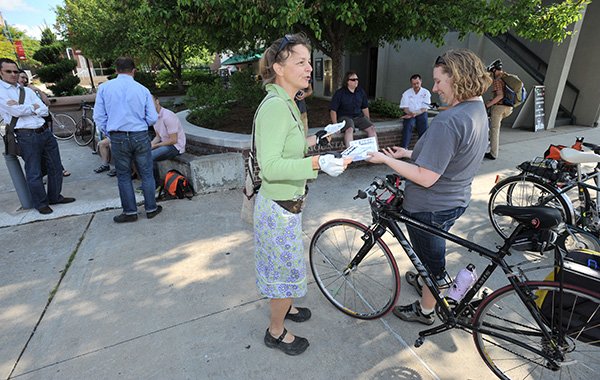 Laura Kelly, center, a longtime bicycling advocate, speaks Friday with Kristin Klemm during an announcement to declare May 12-18 as Bike To Work Week on the Fayetteville square before riders left for a crosstown ride along the city's trail system. Residents are encouraged by the city and Bicycle Coalition of the Ozarks to ride their bicycles to work during the coming week and residents of Benton and Washington counties can track their mileage to be eligible for prizes in the annual Commuter Challenge. 