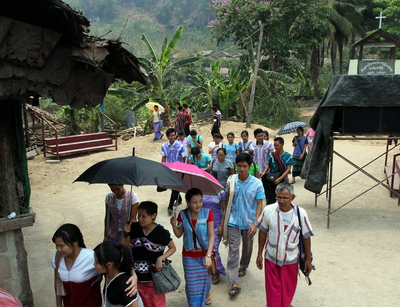 In this photo taken April 12, Karen refugees leave after a church service at Mae La refugee camp in Ta Song Yang district of Tak province, northern Thailand. Karen refugees are now face a future that will dramatically change their constricted but secure, sometimes happy lives. With the end of 50 years of military rule in Myanmar, aid groups are beginning to prepare for the eventual return of one of the world's largest refugee populations, some 1 million in camps and hideouts spread across five countries.