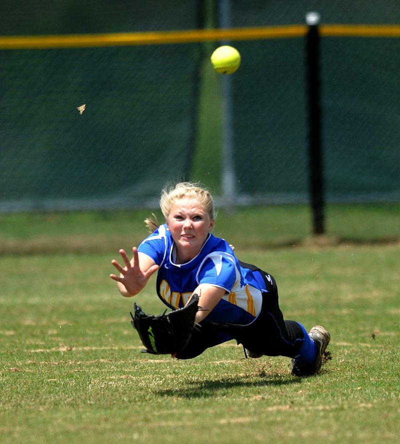  North Little Rock outfielder Hannah Lovercheck makes a diving attempt on a fly ball during Saturday afternoons game against Fayetteville High School at Hunt Park in Springdale.  North Little Rock won the game 3-1 to advance to the next round of the 7A playoffs.