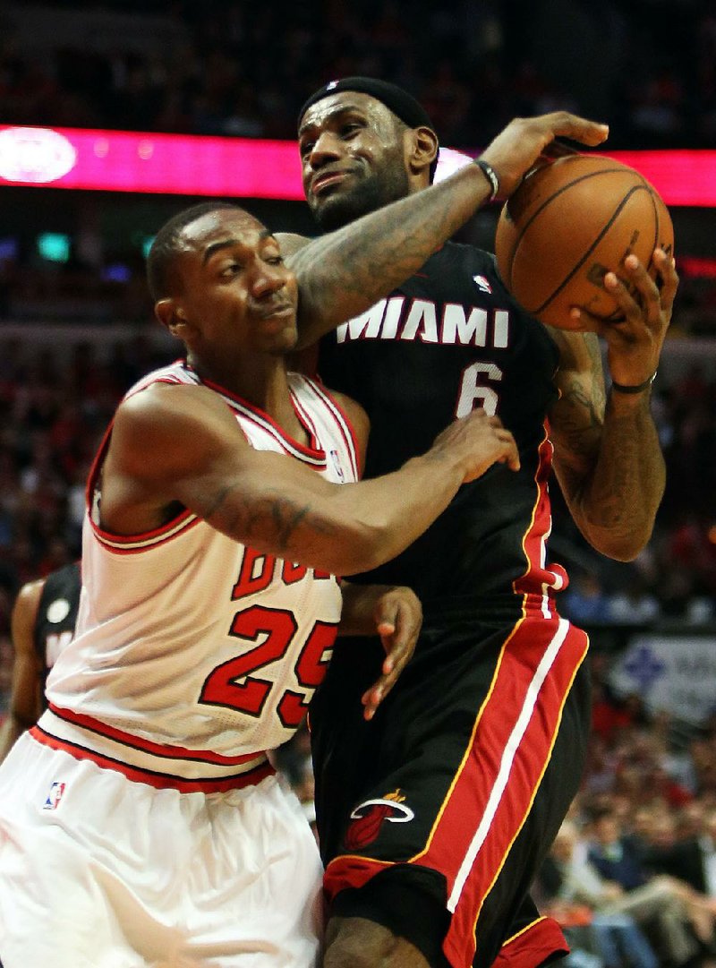 Miami Heat forward LeBron James drives on Chicago Bulls guard Marquis Teague during  Game 4 of an NBA basketball playoffs Eastern Conference semifinal of the Chicago Bulls against the Miami Heat on Monday, May 13, 2013, in Chicago. The Heat won 88-65. MANDATORY CREDIT, MAGS OUT, TV OUT (AP photo / Daily Herald,  Steve Lundy )