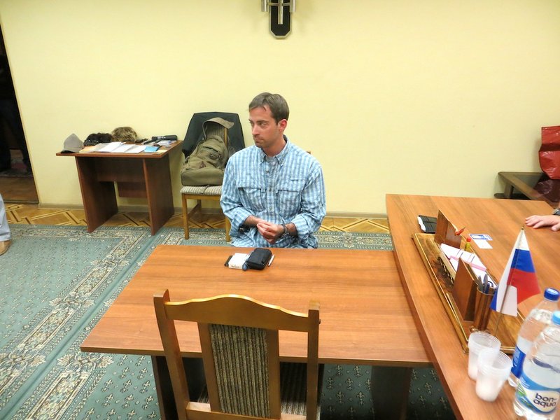 In this handout photo provided by the FSB, acronym for Russian Federal Security Service, a man claimed by FSB to be Ryan Fogle, a third secretary at the U.S. Embassy in Moscow, sits in the FSB offices in Moscow, early Tuesday, May 14, 2013. Russia's security services say they have caught a U.S. diplomat who they claim is a CIA agent in a red-handed attempt to recruit a Russian agent. Ryan Fogle, a third secretary at the U.S. Embassy in Moscow, was carrying special technical equipment, disguises, written instructions and a large sum of money when he was detained overnight, the FSB said in a statement Tuesday. Fogle was handed over to U.S. embassy officials, the FSB, said. 